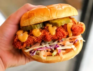 Dave’s Hot Chicken vegan menu options with a crispy plant-based sandwich and fresh toppings.