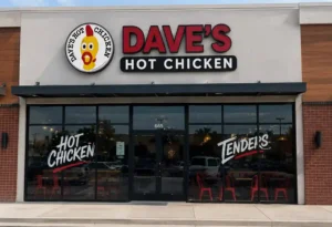 Dave’s Hot Chicken storefront exterior with red signage and glass entrance.