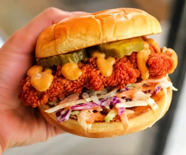 Dave’s Hot Chicken vegan menu options with a crispy plant-based sandwich and fresh toppings.