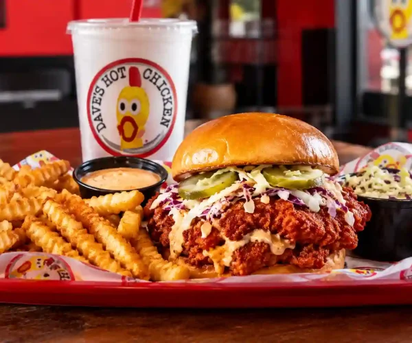 Dave’s Hot Chicken Jeffersonville meal with crispy chicken sandwich, crinkle-cut fries, dipping sauce, coleslaw, and drink.